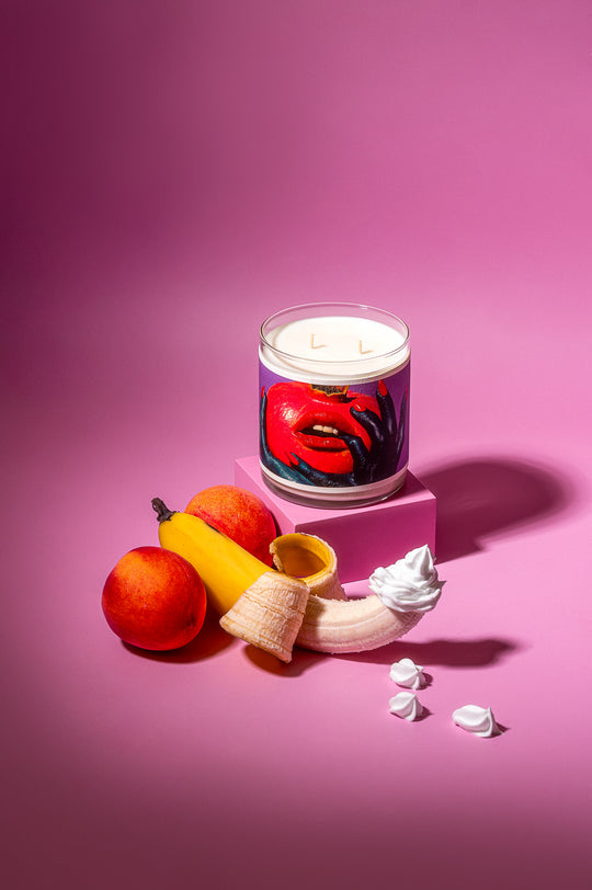 Candle with artistic design on a pink background